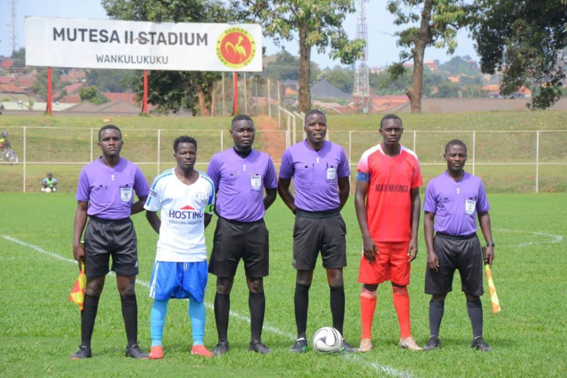 Team captains and match officials during the singing of the Buganda anthem before the match